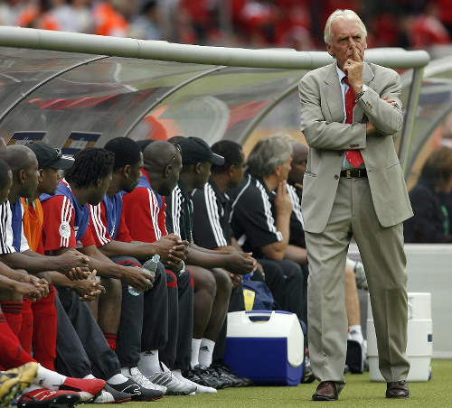 Photo: Trinidad and Tobago Leo Beenhakker (standing) considers his options during 2006 World Cup action against England. (Copyright AFP 2015)