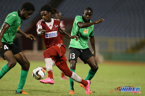 Photo: Central FC winger Jason Marcano (centre) tries to find a way past San Juan Jabloteh players Fabian Reid (right) and Garth Thomas during 2015 Pro League action at the Hasely Crawford Stadium. (Courtesy Kerlon Orr/CA-images/Wired868)