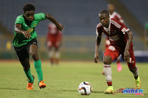 Photo: Central FC attacker Marcus Joseph (right) tries to accelerate past San Juan Jabloteh defender Garth Thomas during 2015 Pro League action at the Hasely Crawford Stadium. (Courtesy Allan V Crane/CA-images/Wired868)