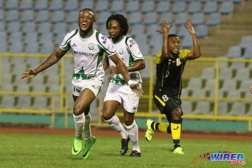 Photo: W Connection attacker Jomal Williams (left) celebrates his opening goal with teammate Andre Toussaint (centre) while Defence Force utility player Curtis Gonzales berates his defence in the 2015 Toyota Classic final. (Courtesy Chevaughn Christopher/Wired868)