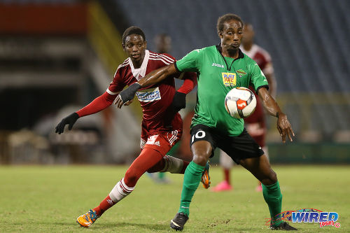 Photo: San Juan Jabloteh attacker Tyrone Charles (right) keeps the ball from Central FC right back Kaydion Gabriel during 2015/6 Pro League action at the Hasely Crawford Stadium. (Courtesy Allan V Crane/CA-images/Wired868)