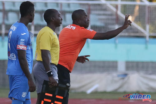 Photo: Naparima College coach Angus Eve (right) prepares to introduce left back Khris Stroud (left) during the 2015 National Intercol final. (Courtesy Chevaughn Christopher/Wired868)