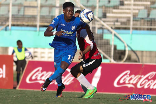 Photo: Naparima College striker Isaiah Hudson (left) turns on St Anthony's College defender Nicholas Moyou during the 2015 National Intercol final in Marabella. (Courtesy Chevaughn Christopher/Wired868)