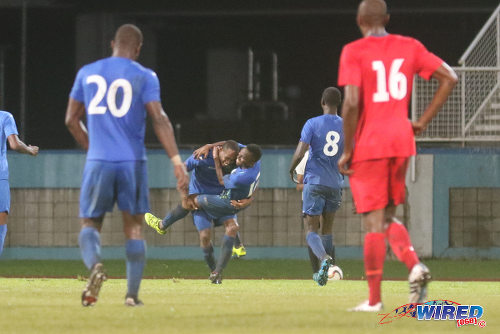 Photo: Police FC winger Christon Thomas (centre) is congratulated by teammate Kevin Lewis after his goal against Club Sando during 2015/16 Pro League action in Couva. (Courtesy Chevaughn Christopher/Wired868)