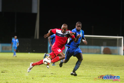 Photo: Police FC defender Elijah Belgrave (right) chases Club Sando striker Kevon Woodley during 2015/16 Pro League action in Couva. (Courtesy Chevaughn Christopher/Wired868)