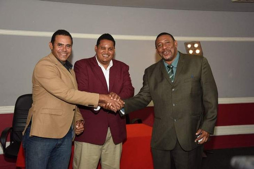 Photo: TTFA president David John-Williams (right) shakes hands with SPORTT Company chairman Michael Phillips (left) while Sport Minister Darryl Smith looks on in 2015. (Courtesy TTFA Media)