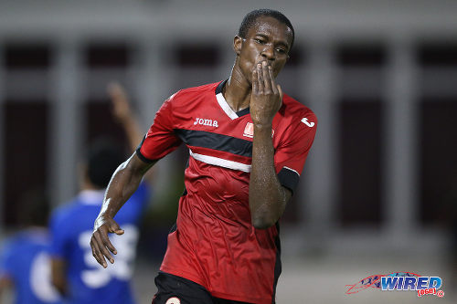 Photo: UTT striker Jamal Creighton gives QPCC a goodnight kiss during their 6-2 win in 2015 CNG NSL Championship Division action at UTT Grounds, Arima. (Courtesy Allan V Crane/CA-images/Wired868)