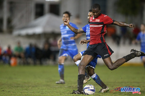 Photo: UTT star striker Jamal Creighton (right) drives towards goal during 2015 CNG NSL Championship Division action last night at UTT Grounds, Arima.  (Courtesy Allan V Crane/CA-images/Wired868)