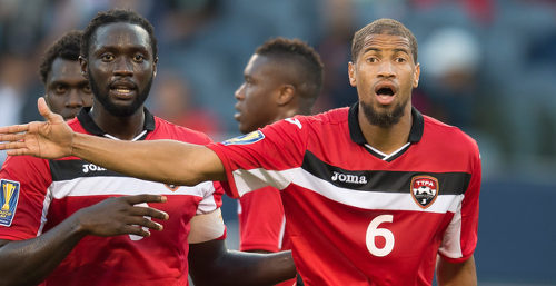 Photo: Trinidad and Tobago captain Kenwyne Jones (left) and defender Radanfah Abu Bakr wait for a set piece during international action in 2015. (Copyright AFP 2016)