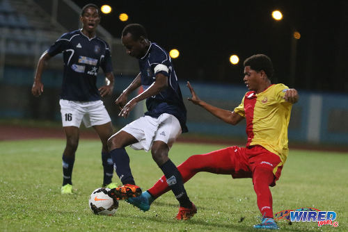 Photo: Morvant Caledonia United captain Kareem "Tiny" Joseph (centre) keeps the ball from 15 year old North East Stars winger Keshon Hackshaw during 2015/16 Pro League action in Couva. Looking on is Morvant Caledonia defender Antonio Joseph. (Courtesy Chevaughn Christopher/Wired868)