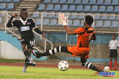 Photo: Central FC midfielder Darren Mitchell (left) strokes past St Ann's Rangers goalkeeper Stefan Berkeley during Pro League action on 9 January 2016. (Courtesy Chevaughn Christopher/Wired868)