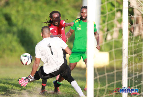 Photo: Guaya United goalkeeper Erskine Johnson (left) makes a crucial save from Matura ReUnited captain Shervin Charles (centre) during 2015/16 CNG NSL Premiership Division action in Matura. Looking on is Guaya United flanker Leroy Jones. (Courtesy Nicholas Bhajan/WIred868)