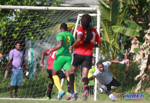 Photo: Guaya United captain Erskine Johnson (right) tries in vain to stop a cross from reaching Matura ReUnited goal scorer Dorian Robinson during 2015/16 CNG NSL Premiership Division action in Matura. (Courtesy Nicholas Bhajan/WIred868)