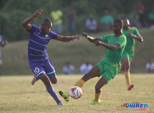 Photo: Defence Force attacker Josimar Belgrave (left) tries to find a way past Guaya United defender Sherlon Campbell during 2015/16 CNG National Super League action in Guayaguare. (Courtesy Nicholas Bhajan/Wired868)