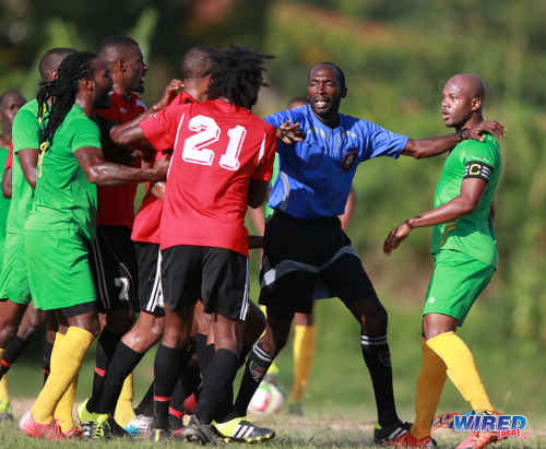 Photo: Referee Hasely Collette (centre) plays peacemaker while then Guaya United captain Ryan Stewart (right) assesses the situation during 2015/16 CNG NSL Premiership Division action at Matura. (Courtesy Nicholas Bhajan/Wired868)