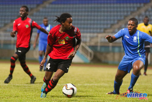 Photo: San Juan Jabloteh winger Sean Bonval (left) takes on Police FC defender Jasimar Ashers in 2015/16 Pro League action in Couva. (Courtesy Chevaughn Christopher/Wired868)