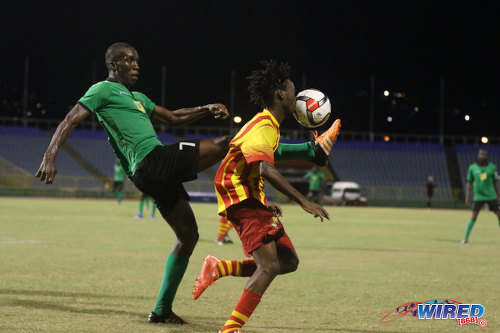 Photo: San Juan Jabloteh forward Jamal Gay (left) flicks the ball into the face of Point Fortin Civic midfielder Akeem Redhead during 2015/16 Pro League action at the Hasely Crawford Stadium. (Courtesy Chevaughn Christopher/Wired868)