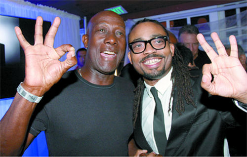 Photo: Prime Minister Dr Keith Rowley (left) poses with soca star Machel Montano during the 2016 Carnival period. (Copyright Trinidad Guardian)