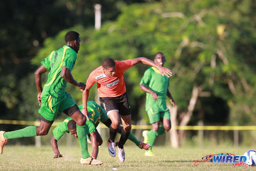 Photo: Real Maracas striker Christian Thomas (centre) runs at the Stokely Vale defence during 2015/16 CNG NSL Premiership action at the Maracas Recreation Ground. (Courtesy Nicholas Bhajan/Wired868)