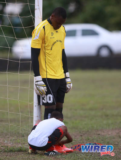 Photo: Matura ReUnited goalkeeper Glenroy Samuel (standing) gets some help from a young football during CNG 2015/16 National Super League Premiership Division action against Petrotrin Palo Seco at the Matura Recreation Ground. (Courtesy Nicholas Bhajan/Wired868)