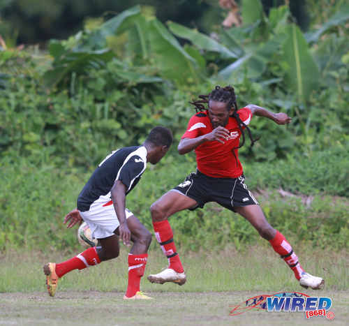 Photo: Matura ReUnited captain and winger Sherwin "Bulbie" Charles (right) takes on Petrotrin Palo Seco full back Isaiah Garcia during 2015/16 CNG National Super League Premiership Division action at the Matura Recreation Ground. (Courtesy Nicholas Bhajan/Wired868)