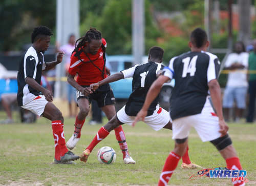 Photo: Matura ReUnited captain and star midfielder Shervin "Bulbie" Charles (centre) is crowded out by Petrotrin Palo Seco players (from right) Cebastian Bailey, Isaiah Garcia and Xavier Seales during 2015/16 CNG National Super League Premiership Division action at the Matura Recreation Ground. (Courtesy Nicholas Bhajan/Wired868)