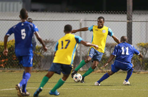 Photo: Club Sando Moruga striker Nigel John (second from right) takes on FC Santa Rosa midfielder Durwin Ross during 2015/16 National Super League (NSL) Premiership Division action at the Marvin Lee Stadium in Macoya. (Courtesy Nicholas Bhajan/Wired868)