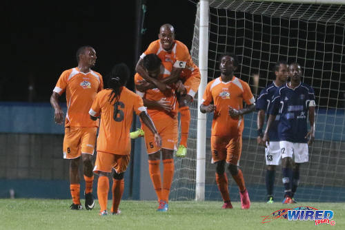 Photo: Then Club Sando captain Kern Cupid takes a lift from goal scorer Amritt Gildharry during 2015/16 Pro League action against Morvant Caledonia United at the Ato Boldon Stadium, Couva. (Courtesy Chevaughn Christopher/Wired868)