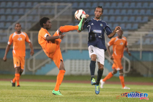 Photo: Club Sando midfielder Akeem Humphrey (centre) flicks the ball over Morvant Caledonia United midfielder Kyle Bartholomew during 2015/16 Pro League action at the Ato Boldon Stadium, Couva. (Courtesy Chevaughn Christopher/Wired868)