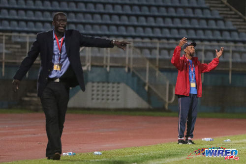 Photo: North East Stars coach Ross Russell (left) and Club Sando coach Anthony Street follow the action from the sidelines during 2015/16 Pro League action in Couva. (Courtesy Chevaughn Christopher/Wired868)