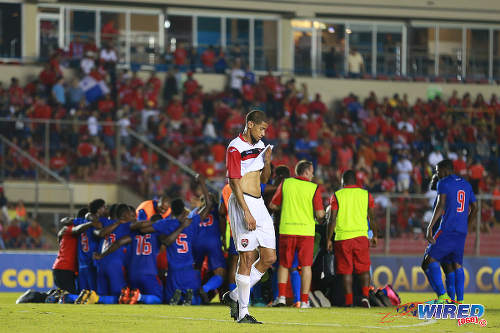 Photo: Trinidad and Tobago defender Radanfah Abu Bakr (centre) walks away while Haiti players celebrate their 1-0 win in the 2016 Copa America play off contest at the Rommel Fernandez Stadium, Panama City on 8 January 2016. (Courtesy Allan V Crane/CA-images/Wired868)