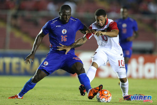 Photo: Trinidad and Tobago attacker Shahdon Winchester (right) tries to escape from Haiti defender Jean Marc Alexandre during the 2016 Copa America play off contest at the Rommel Fernandez Stadium, Panama City on 8 January 2016. (Courtesy Allan V Crane/CA-images/Wired868)