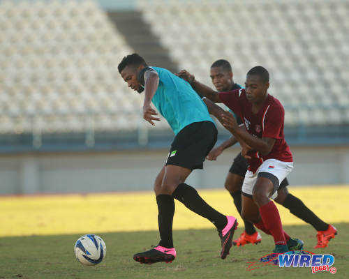 Photo: WASA FC winger Nathan Julien (left) tries to escape from La Horquetta SA attacker Kerron St Cyr during 2015/16 CNG National Super League Premiership Division action yesterday at the Larry Gomes Stadium, Malabar. (Courtesy Nicholas Bhajan/Wired868)