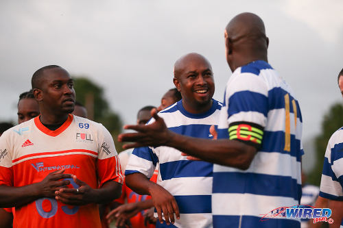 Photo: Wired868 director Lasana Liburd (centre) and captain Leonson Lewis (right) conduct a post-mortem while Darin Lewis spies on the opposition during the 2016 Wired868 Football Festival. (Courtesy Allan V Crane/Wired868)