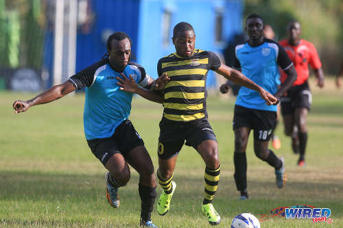 Photo: Defence Force attacker Josimar Belgrave (right) holds off WASA defender and captain Akil Harley during CNG National Super League Premiership Division action yesterday in St Joseph. (Courtesy Nicholas Bhajan/Wired868)