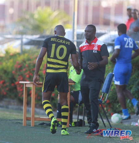 Photo: Defence Force coach Kelshall Alexander (right) offers a hand to star attacker Josimar Belgrave  during 2015/16 NSL Premiership Division action in Macoya. (Courtesy Nicholas Bhajan/Wired868)