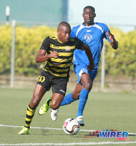 Photo: Defence Force attacker Josimar Belgrave (left) heads for goal  during NSL Premiership Division action against Stokely Vale FC on 21 February 2016 in Macoya. (Courtesy Nicholas Bhajan/Wired868)