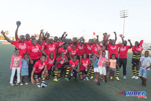 Photo: The Defence Force Football Club celebrates clinching the 2015/16 National Super League Premiership Division title on 21 February 2016 at the Marvin Lee Stadium in Macoya. (Courtesy Nicholas Bhajan/Wired868)