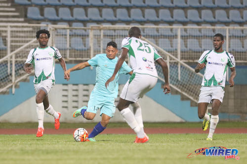 Photo: Atlantico FC attacker Leinner Chirinos (centre) takes on W Connection players (from right) Kurt Frederick, Daneil Cyrus and Triston Hodge during 2016 Caribbean Club Championship action last night in Couva. (Courtesy Chevaughn Christopher/Wired868)