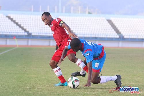 Photo: Central FC captain Leston Paul (left) holds off St Ann's Rangers defender Sedale McLean during TT Pro League action on 20 February 2016. (Courtesy Chevaughn Christopher/Wired868)