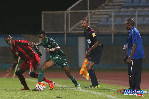 Photo: W Connection attacker Dimitrie Apai (right) takes on Inter Moengo Tapoe defender Anduelo Amoeferie during CFU Caribbean Club action at Couva on 28 February 2016. (Courtesy Chevaughn Christopher/Wired868)