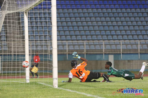 Photo: W Connection attacker Dimitrie Apai (right) beats Club Sportif Moulien goalkeeper Fabien Beral during 2016 Caribbean Club Championship action in Couva on 26 February 2016. (Courtesy Chevaughn Christopher/Wired868)