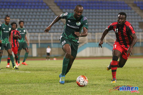 Photo: W Connection defender Daneil Cyrus (left) tries to take the ball around Inter Moengo Tapoe attacker Kareem Kwasie during CFU Caribbean Club action at Couva on 28 February 2016. (Courtesy Chevaughn Christopher/Wired868)