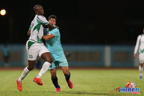 Photo: W Connection defender Daneil Cyrus (left) tangles with Atlantico FC flanker Adrian De Jesus in Caribbean Club Championship action last night in Couva. (Courtesy Allan V Crane/CA-images/Wired868)