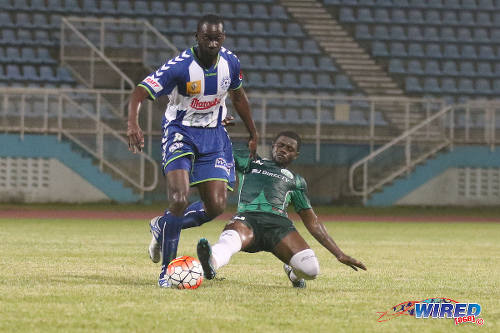 Photo: W Connection midfielder Hughtun Hector (right) tackles Club Sportif Moulien midfielder Fabien Beral during 2016 Caribbean Club Championship action in Couva on 26 February 2016. (Courtesy Chevaughn Christopher/Wired868)