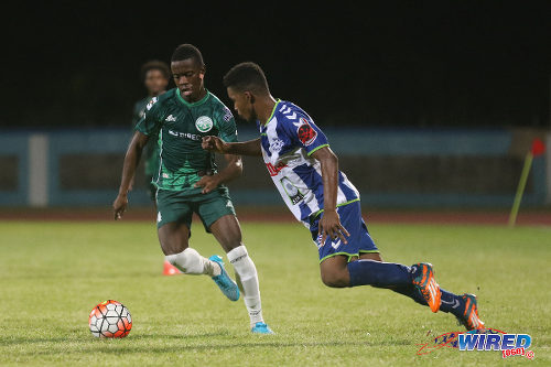 Photo: W Connection attacker Jabari Mitchell (left) in action against Club Sportif Moulien during 2016 Caribbean Club Championship action in Couva on 26 February 2016. (Courtesy Chevaughn Christopher/Wired868)