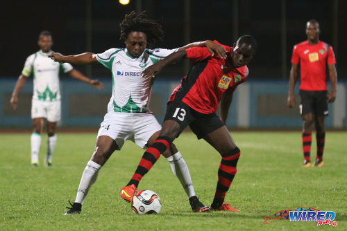 Photo: Battle of the maestros. San Juan Jabloteh midfielder Fabian Reid (right) tries to hold off W Connection playmaker Andre Toussaint during 2015/16 Pro League action at the Ato Boldon Stadium. (Courtesy Chevaughn Christopher/Wired868)