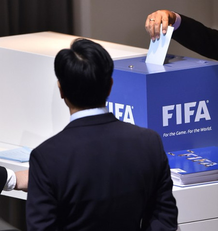 Photo: A FIFA delegate prepares to cast his ballot in the 2016 FIFA presidential election today in Zurich. (Copyright AFP 2016/Fabrice Coffrini)