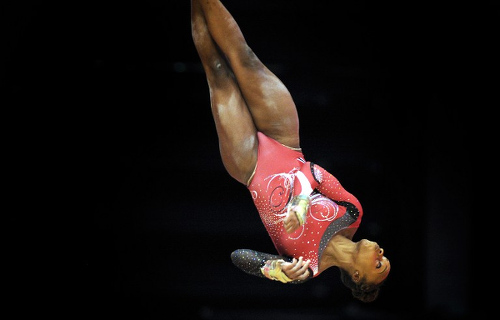 Photo: Thema Williams of Trinidad And Tobago competes on the uneven bars during the 2015 World Gymnastics Championship in Glasgow, Scotland, on October 23, 2015. (Copyright AFP 2016/Andy Buchanan)