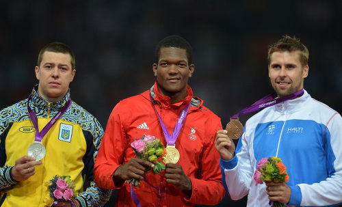 Photo: Trinidad and Tobago's Keshorn Walcott (centre) shows off his gold medal at the London 2010 Olympics. Anthony N Sabga has joined the country's elite gold medal club for his deft finish in the artistic tendering event. (Copyright AFP 2016/Johannes Eisele)